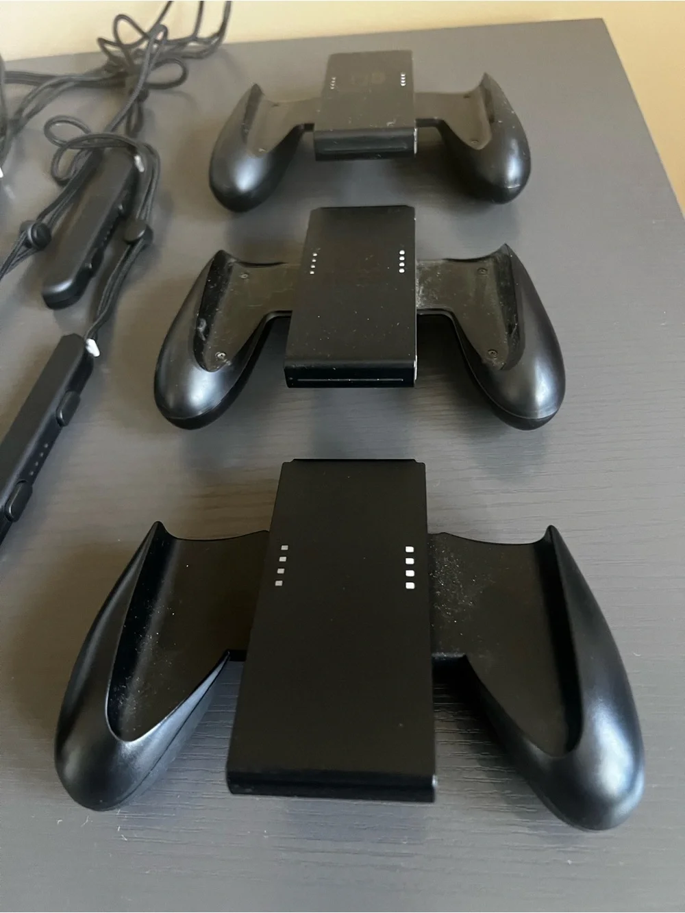 Nintendo Switch Joy-Con comfort grip and a black Joy-Con wrist strap. Used